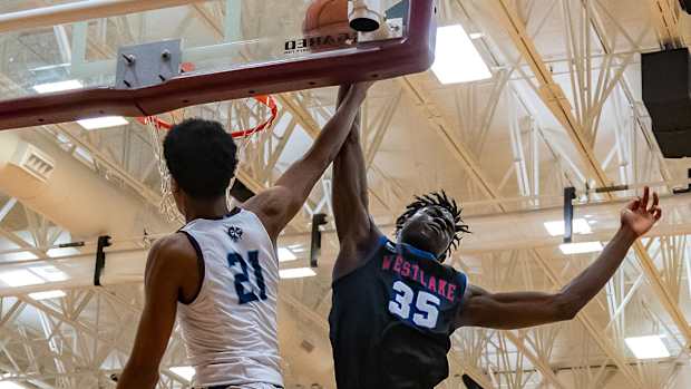 Westlake Chaparrals center Wonder Kahozi (35) bocks the slam dunk attempt by Fort Bend Clements Rangers guard Rahman Olajuwon (21) during the second period at the William Roberts Memorial Tournament on Saturday, Dec 30, 2023, at Round Rock High School - Round Rock, TX.